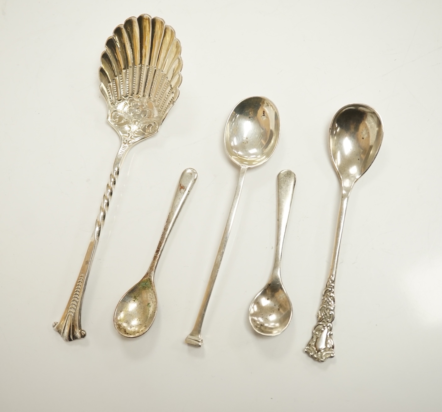 A group of assorted silver including a George III Irish silver basing spoon, Dublin, 1804, 29.5cm, a similar sauce ladle, two Georgian berry spoons, a late Victorian heart shaped photograph frame, a heart shaped pill box